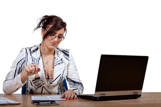 Young female office worker gives a stamp on documents