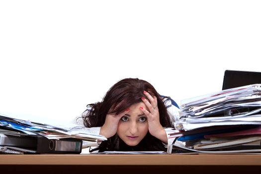 Young female office worker helplessly looking at the pile of papers with place for text