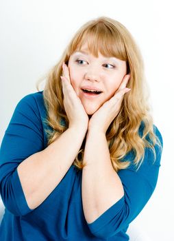 Portrait of a surprised young blonde woman with overweight