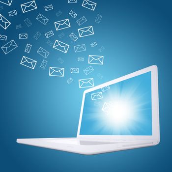 Emails fly out of laptop screen. The concept of e-mailing