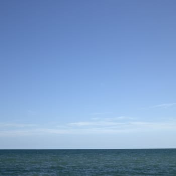 Beautiful turquoise wavy ocean with blue sky