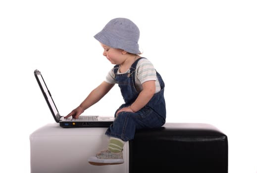 Little boy sitting with a laptop isolated on the white