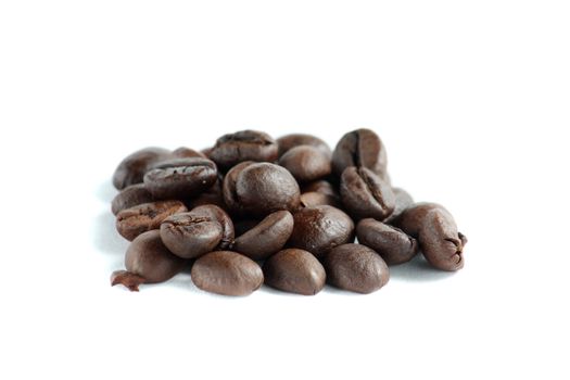 A lot of roasted coffee beans at dark background