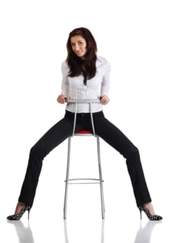 Girl sitting on the bar chair at white background