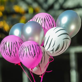 pink and white zebra balloons at breast cancer awareness event