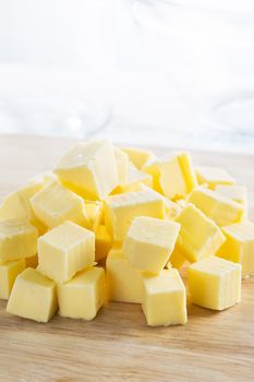 Fresh cubes of butter on board