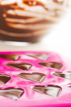 Warm chocolate just poured into chocolate mold.