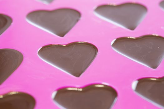 Close up of warm chocolate that has just been poured into a heart mold