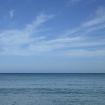 Turquoise ocean with blue sky and white clouds