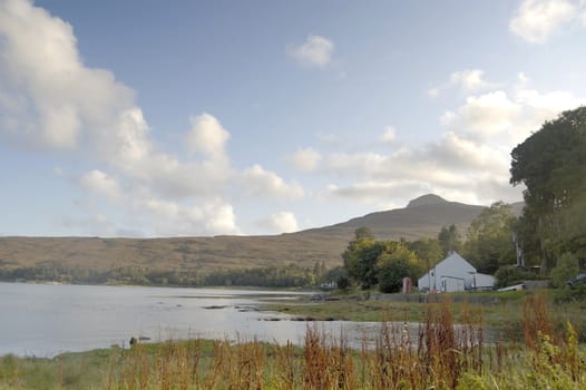 A white house overlooks the pretty bay at Kinloch on the island of Rum, Scotland