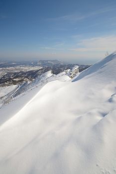 Candid off-piste ski slope in scenic background of high mountain peak