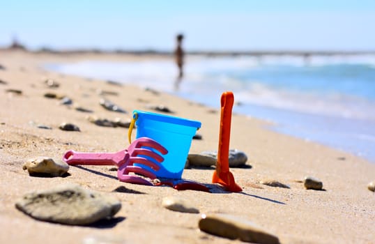 Plastic bucket on the beach near the sea