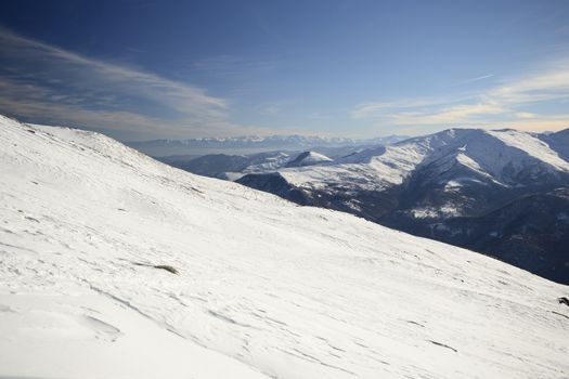 Candid off-piste ski slope in scenic background of high mountain peak