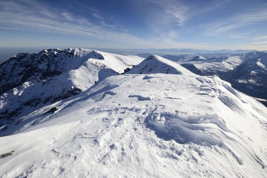 Candid off-piste ski slope in scenic background of high mountain peak