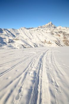 Ski touring (back country skiing) in majestic high mountain scenery, italian Alps