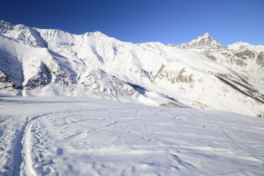 Ski touring (back country skiing) in majestic high mountain scenery, italian Alps