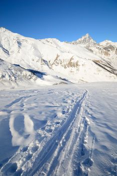 Ski touring (back country skiing) in majestic high mountain scenery, italian Alps