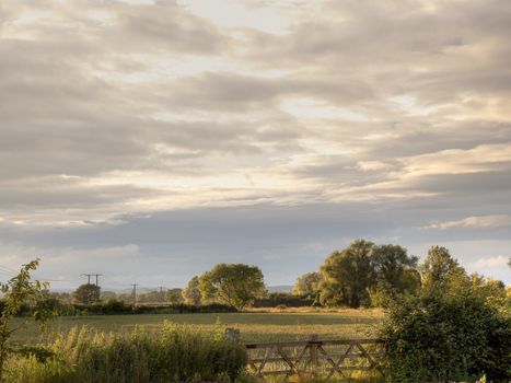 Field and gate background at sunset, Gloucestershire, England.