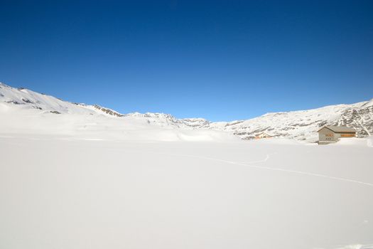 Candid off piste ski slope in scenic background of high mountain peaks, Gran Paradiso National Park, italian Alps