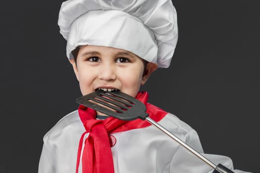 Food, Little boy preparing healthy food on kitchen over grey background, cook hat