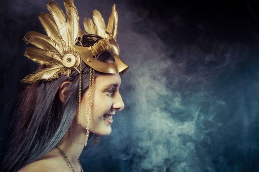 Vintage warrior woman with gold mask, long hair brunette. Long hair. Profile. Studio shot