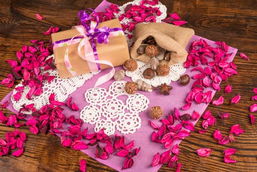 Valentines gift in a still life with flower petals and treats