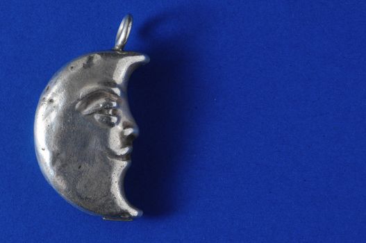 Half Moon Silver Jewel over a Colored Background