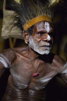 JOW VILLAGE, IRIAN JAYA PROVINCE, NEW GUINEA, INDONESIA - JUNE 28: The Portrait Asmat warrior with a traditional painting and coloring on a face.June 28, 2012 in Jow Village, Asmat province, Indonesia