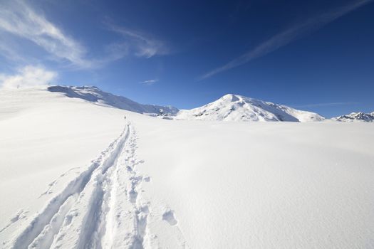 Ski touring (back country skiing) in majestic high mountain scenery, italian Alps