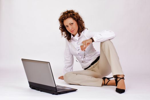 portrait of  a young girl with a lap top at home on the floor