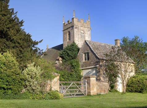 Pretty village church and cottage at Cutsdean, Gloucestershire, England.
