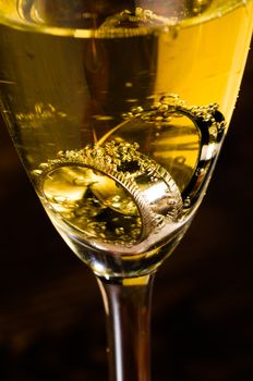 Champagne glass and two rings on the bottom of it