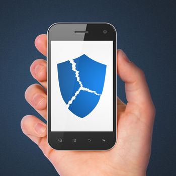 Security concept: hand holding smartphone with Broken Shield on display. Mobile smart phone on Blue background, 3d render