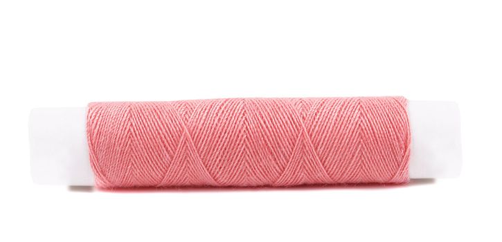 Close up of pink coil threads. Isolated on a white background.