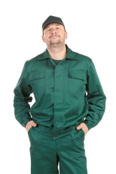 Worker in green workwear with hands in the pockets