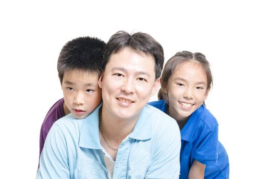 Children with father smiling to the camera 