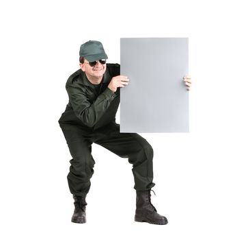 Man in workwear holds paper sheet. Isolated on a white background.