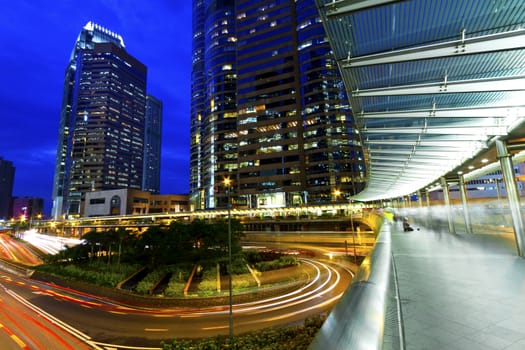 The light trails on the modern building background in Hong Kong