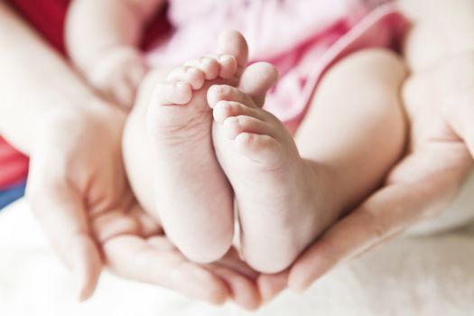 A close-up of tiny baby feet