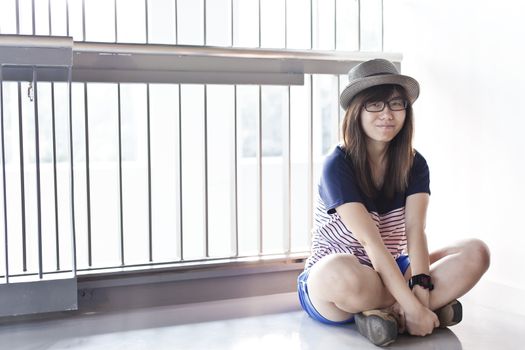 Asian woman sitting with smile