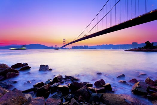 Modern bridge at coast in sunset