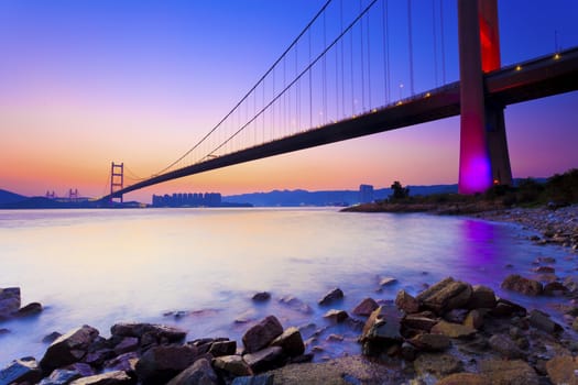 Sunset at modern bridge along coast