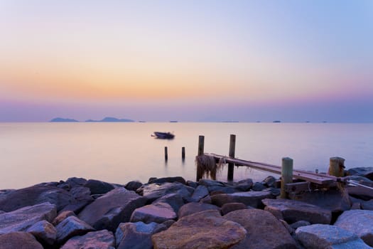 Wooden bridge at sunset along coast