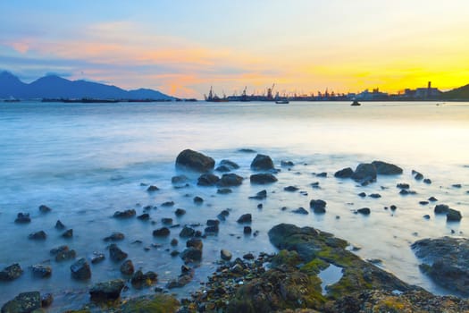 Sunset along coast with sea stones