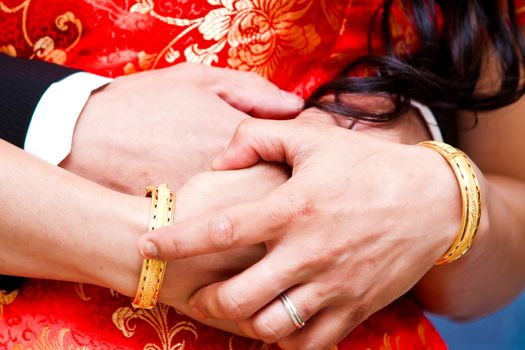 Couple holding hands in wedding day