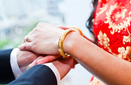 Bride and groom wear wedding rings