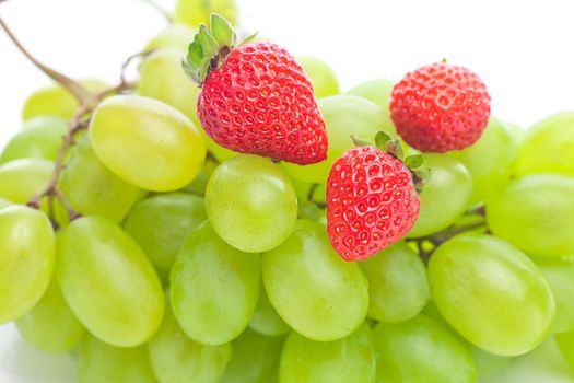 bunch of white grapes and strawberries isolated on white