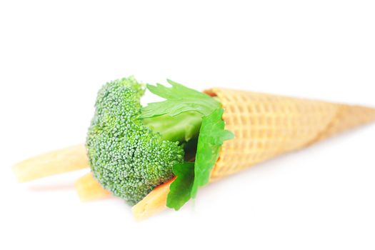 carrot, celery, broccoli in a waffle cone isolated on white