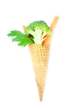 carrot, celery, broccoli in a waffle cone isolated on white