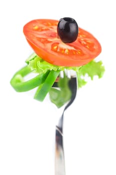 fork,black olive,lettuce, tomato and pepper isolated on white